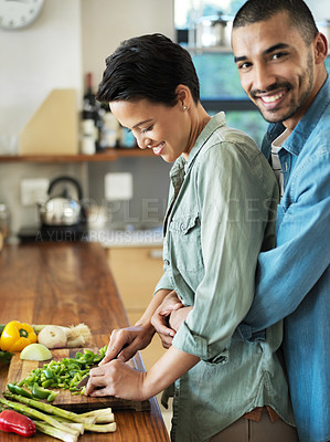 Buy stock photo Healthy food, smile and couple hug in kitchen for love, vegan cooking and bonding together with date. Vegetables, happy man and woman with knife for cutting, nutrition meal or preparation in home