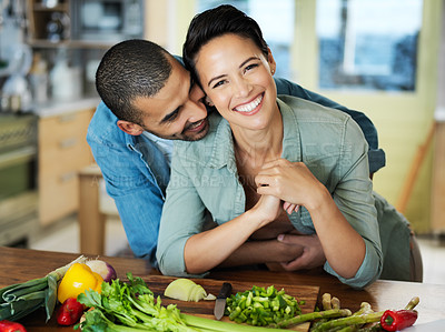 Buy stock photo Cooking, smile and couple embrace at kitchen counter for love, healthy food and bonding together on date. Vegetables, happy man and vegan woman for dinner, nutrition meal or preparation in home