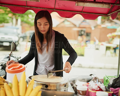 Buy stock photo Shot of a food vendor in Thailand preparing a tasty snack