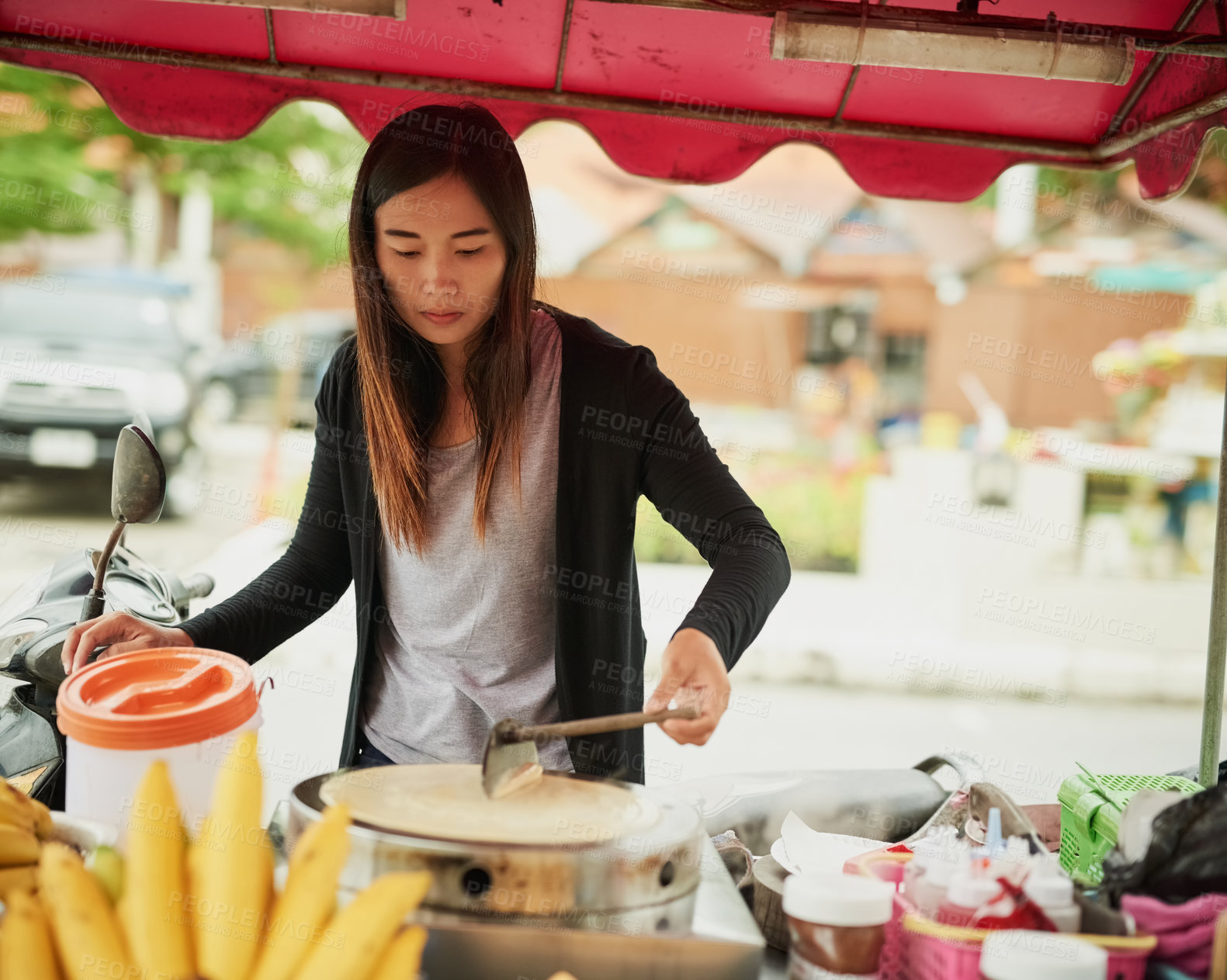 Buy stock photo Shot of a food vendor in Thailand preparing a tasty snack