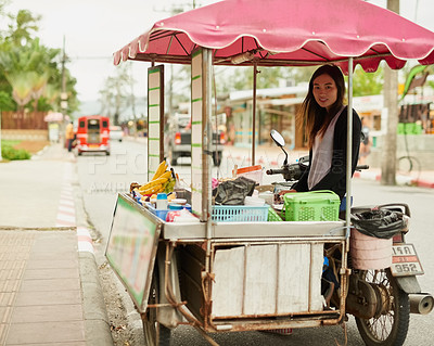 Buy stock photo Portrait of a young food vendor waiting by her stall in Thailand