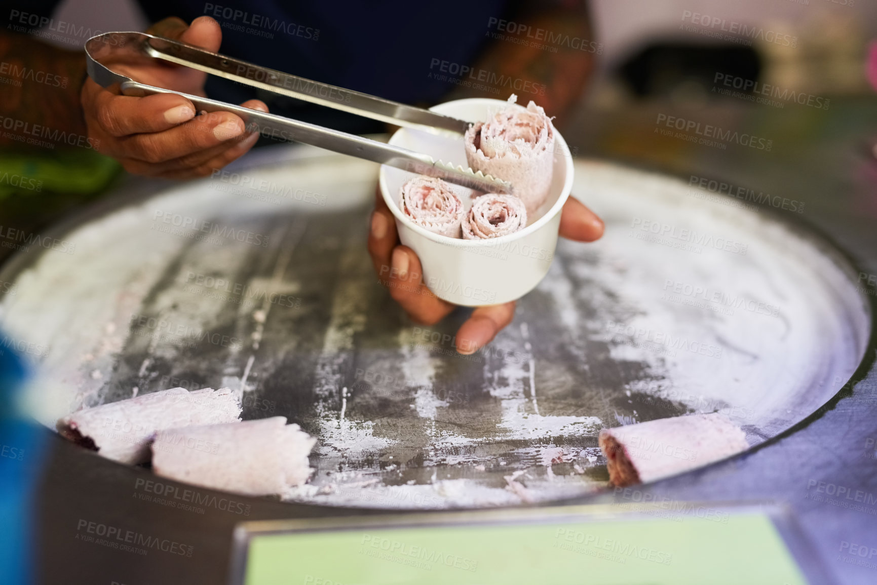 Buy stock photo Shot of an unidentifiable food vendor preparing a sweet treat at a market stall