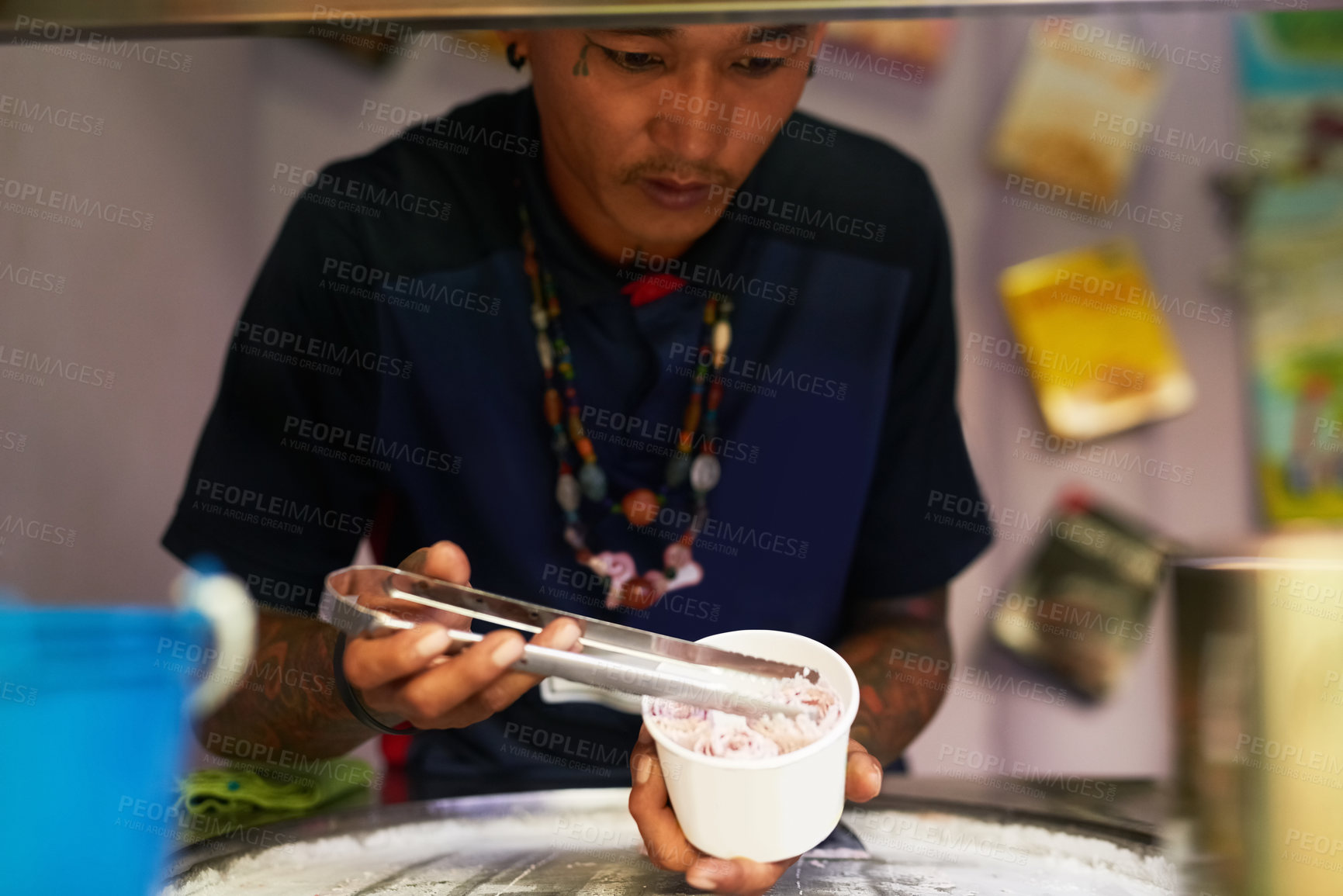 Buy stock photo Shot of a food vendor preparing a sweet treat at a market stall