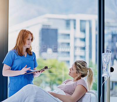 Buy stock photo Shot of a young doctor giving a patient feedback in a hospital ward