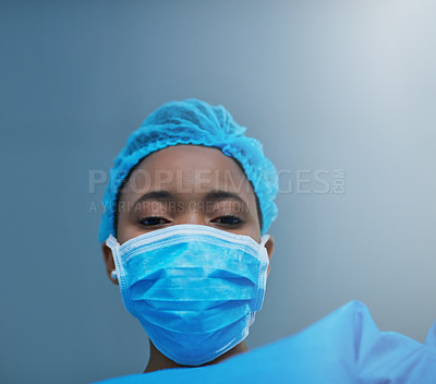 Buy stock photo Shot of a young surgeon performing a medical procedure in an operating room