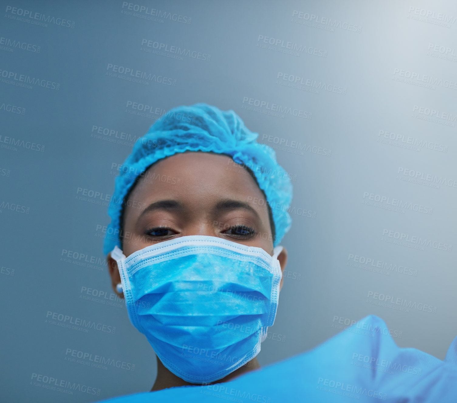 Buy stock photo Shot of a young surgeon performing a medical procedure in an operating room