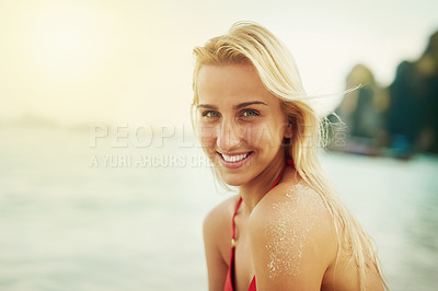Buy stock photo Shot of a young woman spending the day at the beach