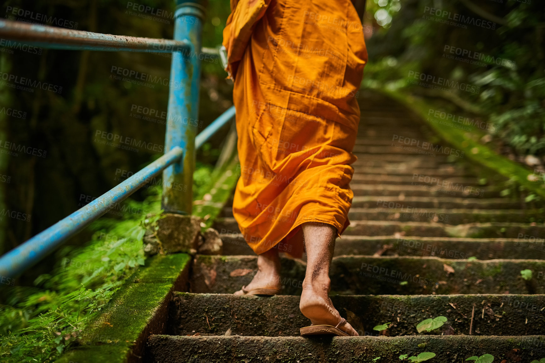 Buy stock photo Rearview shot of a buddhist monk climbing a flight of stone steps
