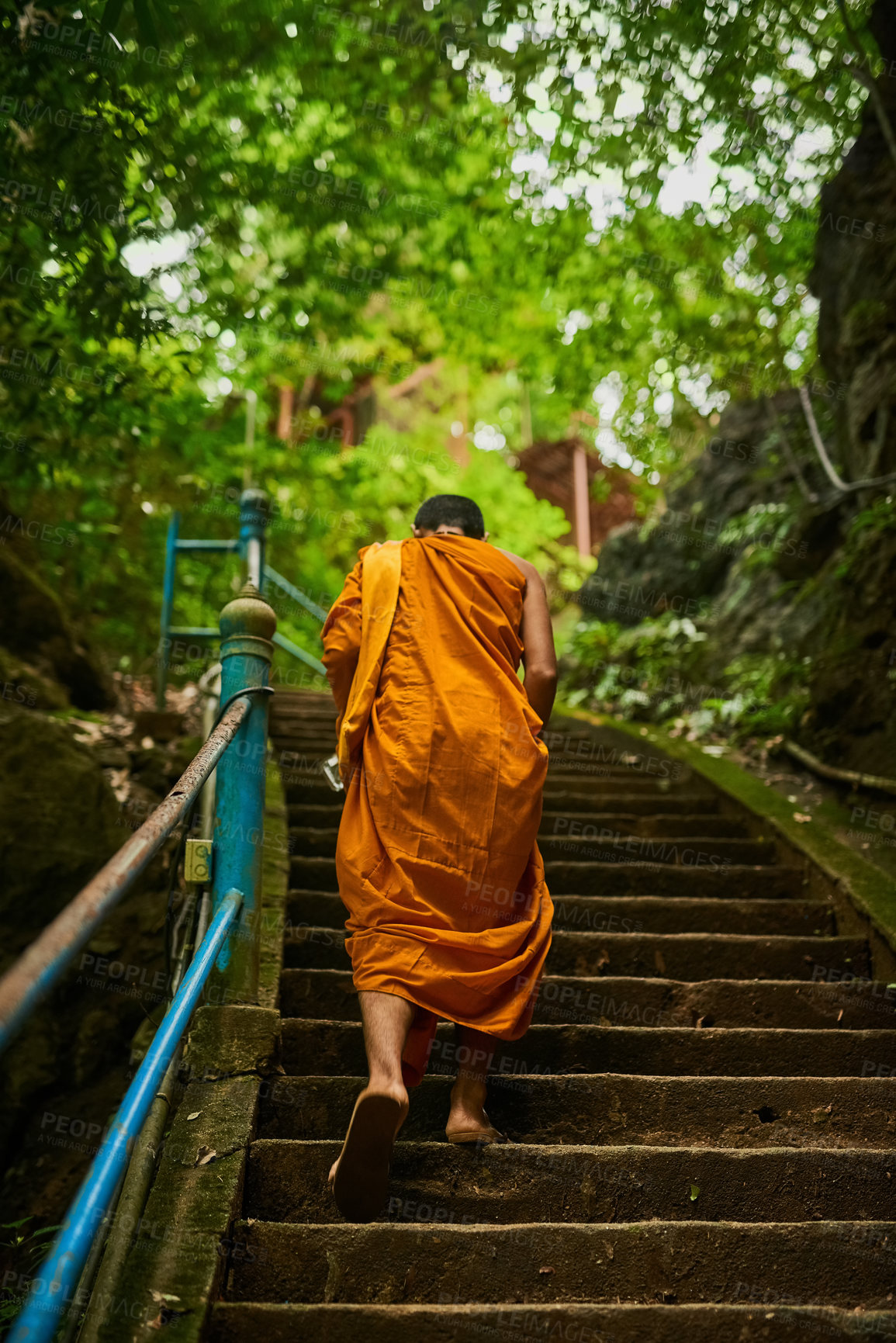 Buy stock photo Back, Asian man and walking to temple for culture, religion and architecture in Thailand. Robes, traditional clothes and steps to path of spiritual buddhist building for faith, worship and history