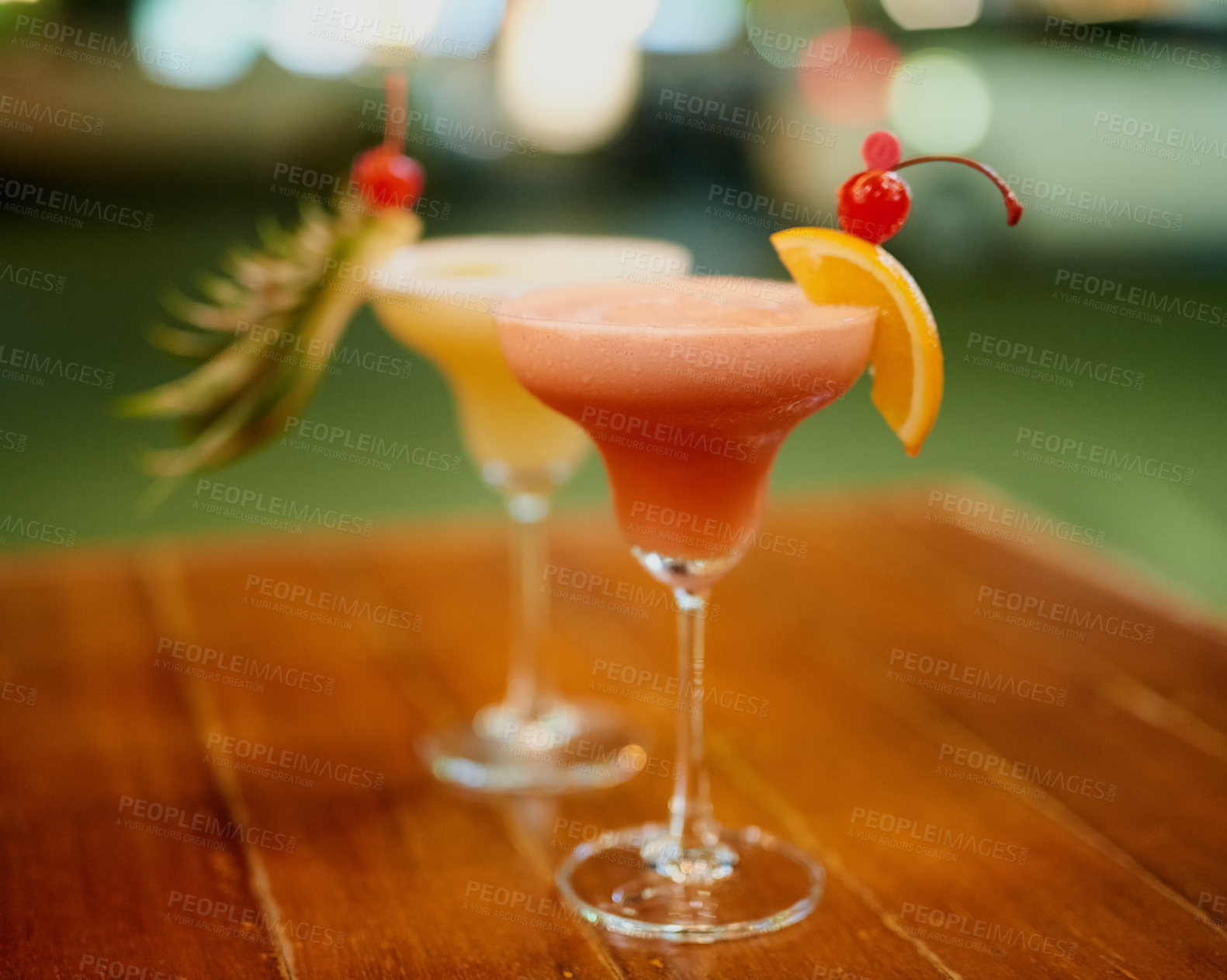 Buy stock photo Shot of two fruity cocktails on a table in a bar