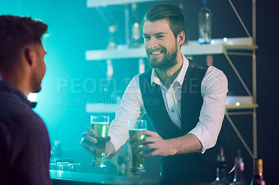 Buy stock photo Cropped shot of a bartender serving drinks to a man in a nightclub