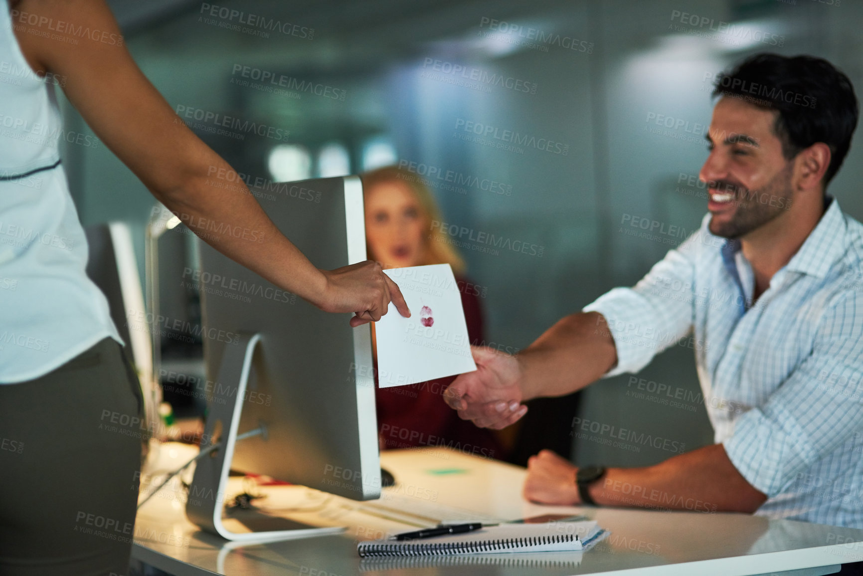 Buy stock photo Shot of a love note being passed from one colleague to another