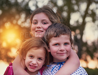 Buy stock photo Cropped shot of three siblings standing outside