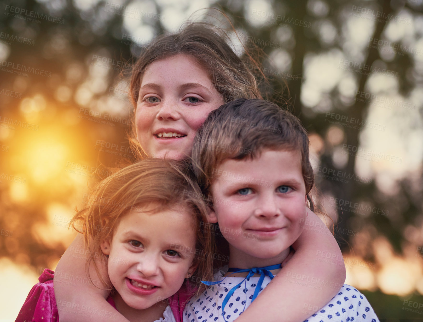 Buy stock photo Cropped shot of three siblings standing outside