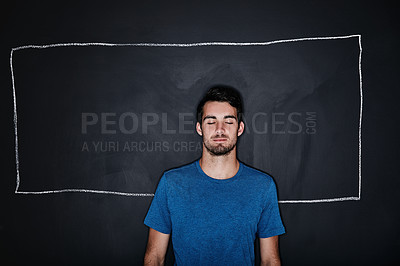 Buy stock photo Studio shot of a young man posing against a gray background