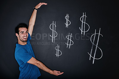 Buy stock photo Studio portrait of a young man gesturing over an illustration of a dollars against a dark background