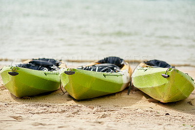 Buy stock photo Still life shot of three canoes on the shore of the beach