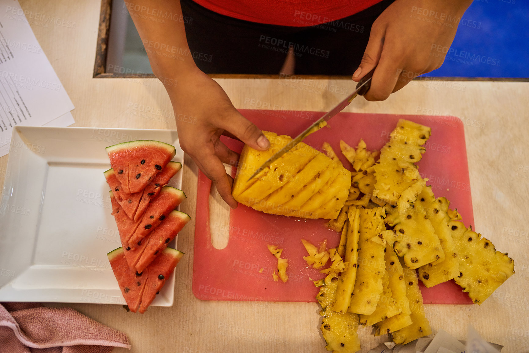 Buy stock photo Shot of an unidentifiable chef's hands as she cuts fruit in the kitchen