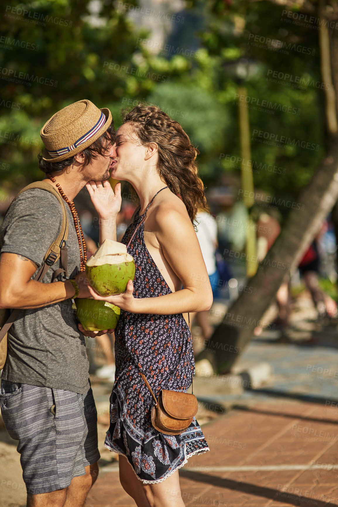 Buy stock photo Travel, holiday and couple with kiss in city for outdoor adventure, romance and honeymoon together. Cocktail, man and woman with affection in street for commitment, love or tourist vacation in Brazil