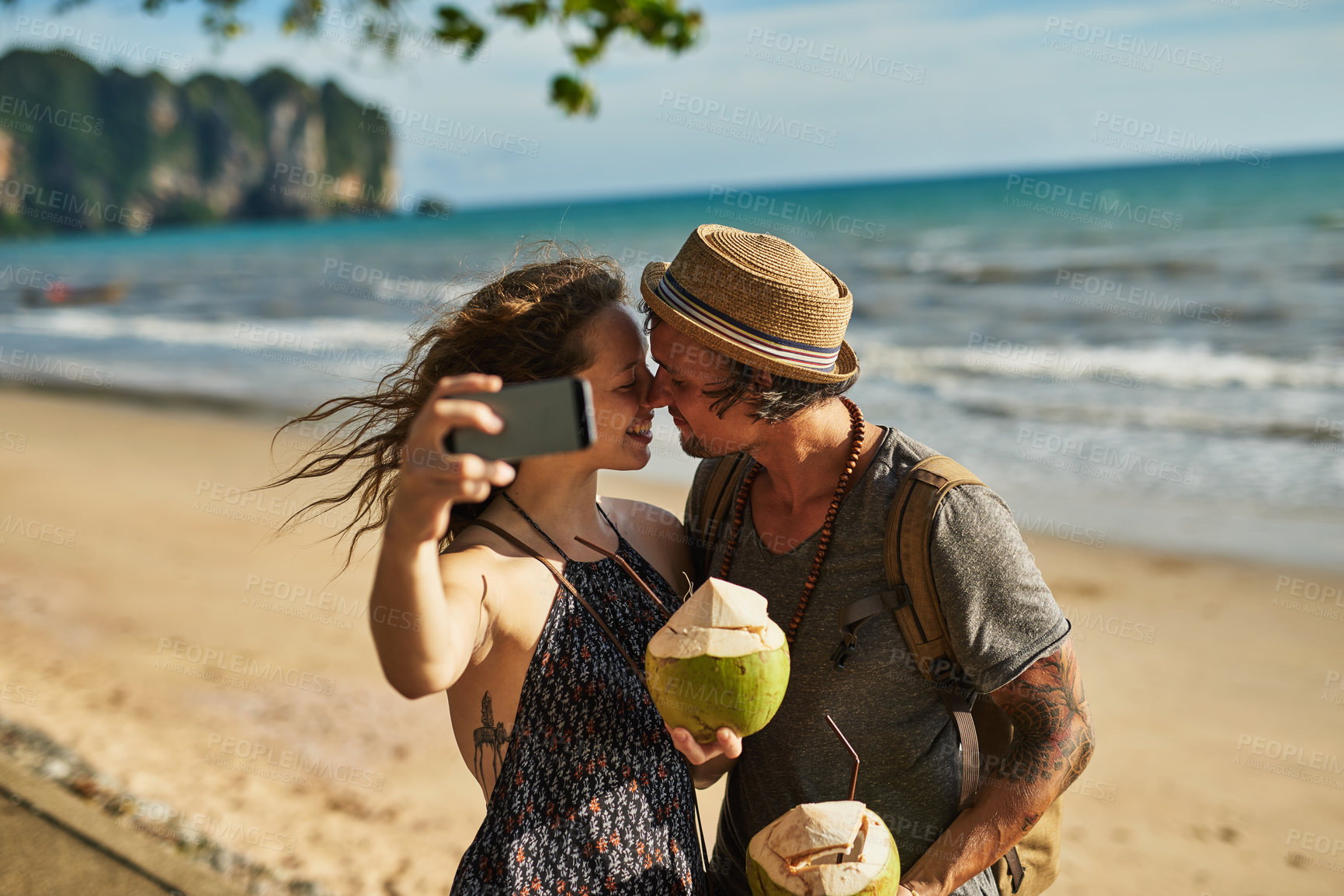 Buy stock photo Love, couple and selfie for picture on beach for social media update, photography and coconut drink for memory. Happy, man and woman travel to tropical ocean together for summer vacation in Greece