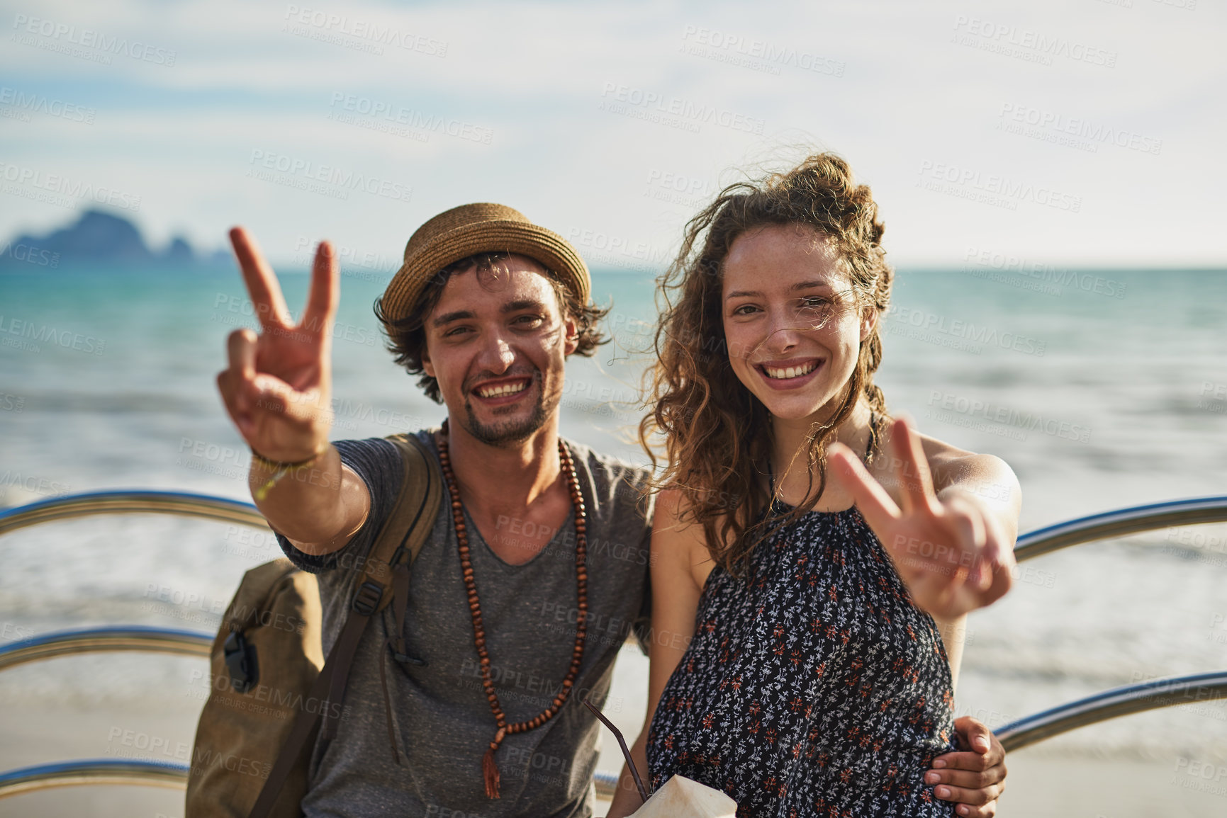 Buy stock photo Man, woman and beach holiday with peace sign for wellness, happiness for adventure travel in Europe. Happy couple, together and portrait with finger gesture by ocean for vacation, unity or expression