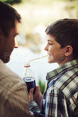 Buy stock photo Love, father and child drinking soda in a park with support, care and bonding on adventure in nature together. Cold drink, straw and parent with kid in forest for camping, learning or travel journey