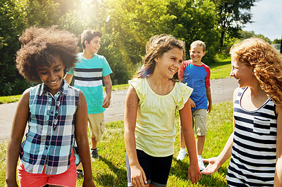 Buy stock photo Cropped shot of a group of diverse and happy kids hanging out together outside