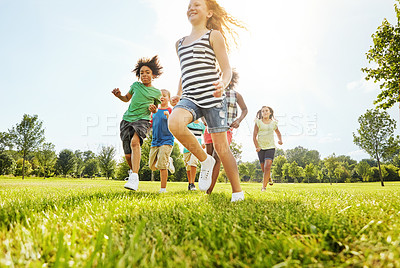 Buy stock photo Happy children, playing and running with friends in nature for fun, playful day or sunshine at park. Diversity or group of excited kids or youth enjoying sunny outdoor holiday on grass field together