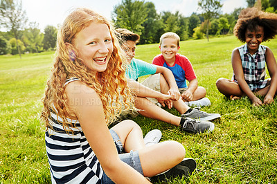 Buy stock photo Portrait of a group of diverse and happy kids sitting together on the grass outside