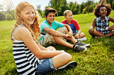 Buy stock photo Portrait of a group of diverse and happy kids sitting together on the grass outside