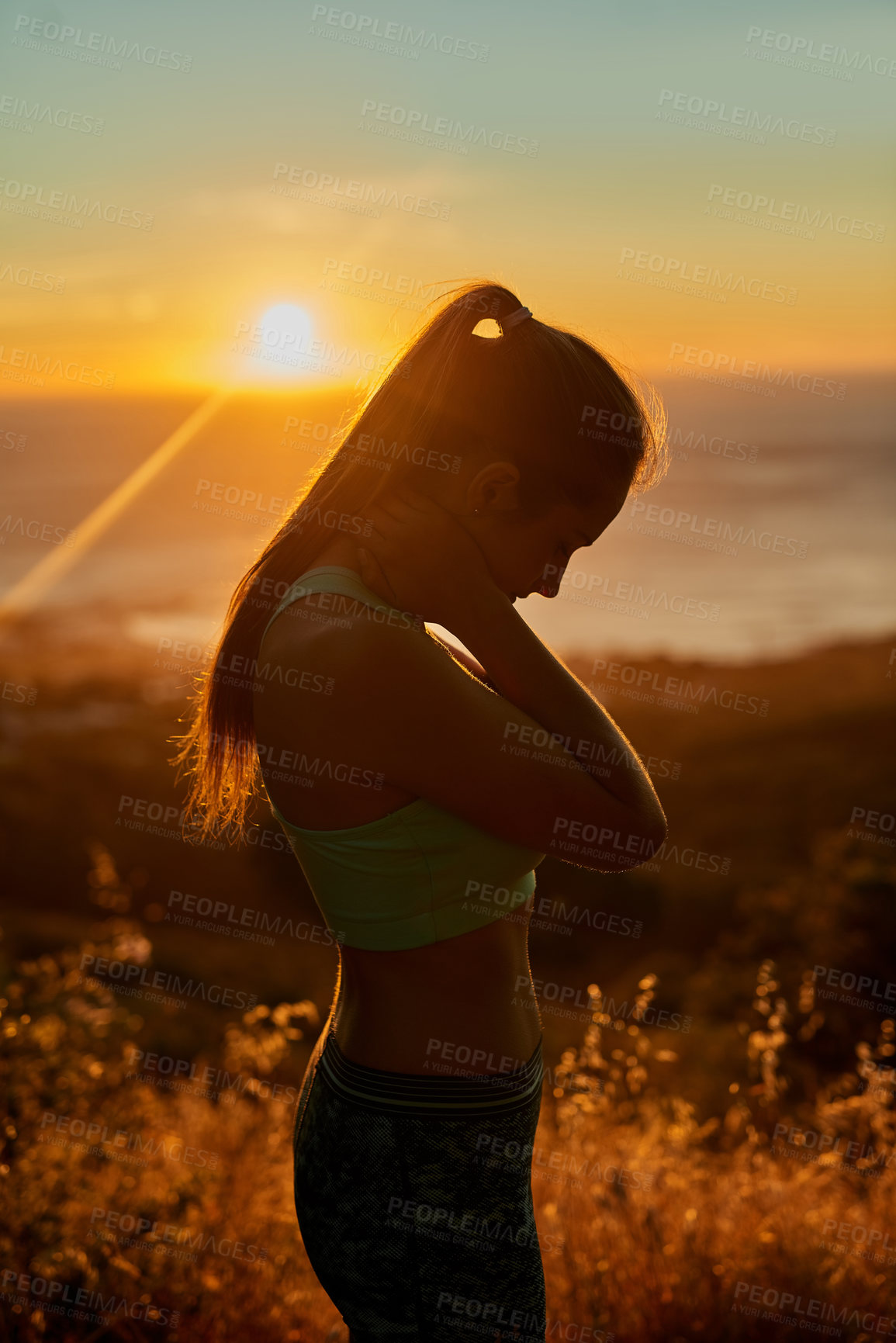 Buy stock photo Cropped shot of a young woman taking a break during her morning run