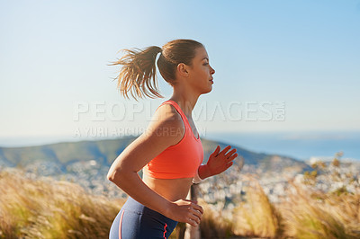 Buy stock photo Cropped shot of an attractive young woman running in the early morning