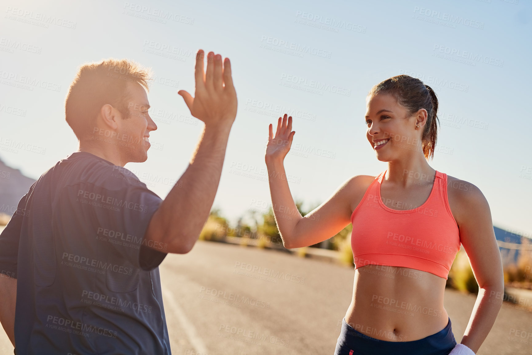 Buy stock photo Cropped shot of two young people high fiving during their workout