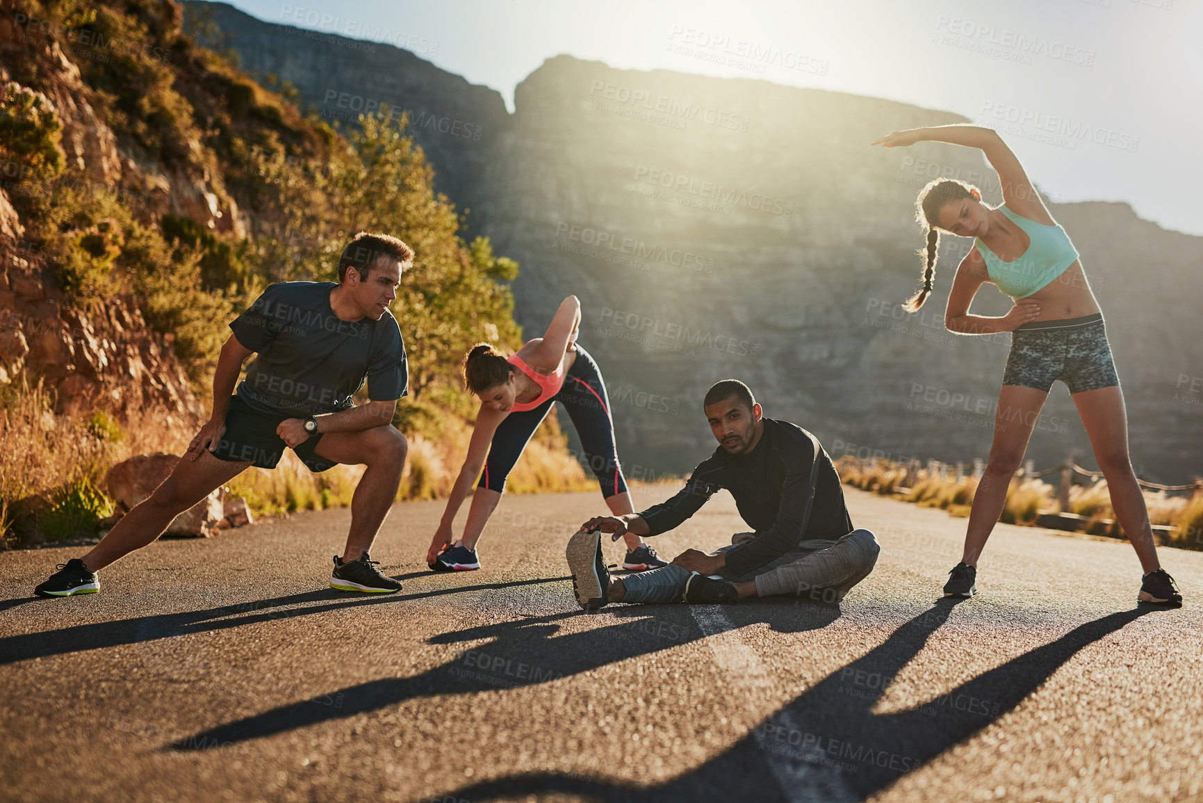 Buy stock photo Friends, runner and stretching by mountain in portrait on road with diversity, wellness and exercise. People, men and woman with training, workout and ready with warm up for muscle health in nature