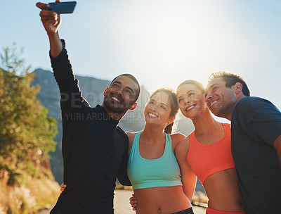 Buy stock photo Shot of a group of friends taking a selfie while out for a workout