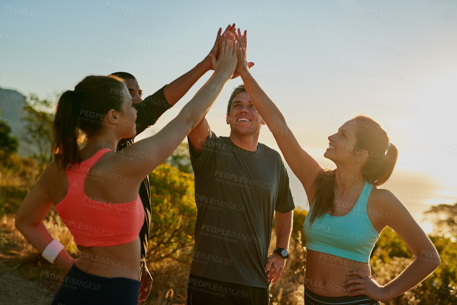 Buy stock photo Friends, group and high five for running exercise on mountain for park trail, support or fitness. Men, women and hand gesture for training goals or sport target with celebration, morning or nature