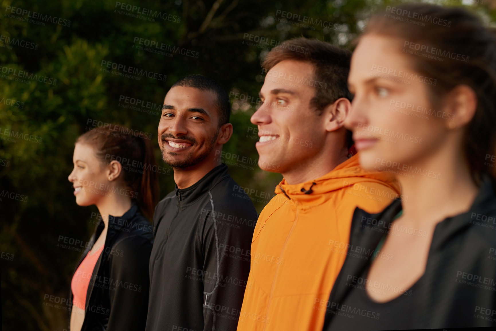 Buy stock photo Cropped shot of a fitness group standing in a row