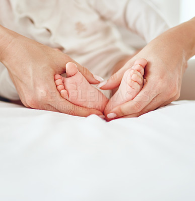 Buy stock photo Closeup shot of a mother holding her baby boy's feet