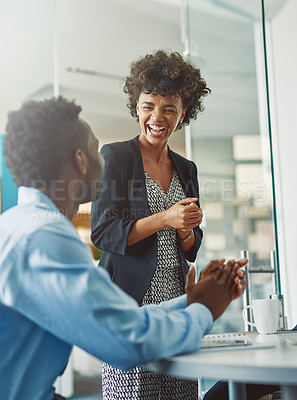 Buy stock photo Cropped shot of colleagues laughing together in an office