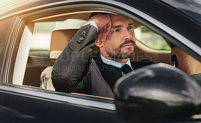 Buy stock photo Cropped shot of a handsome businessman looking annoyed while driving into work