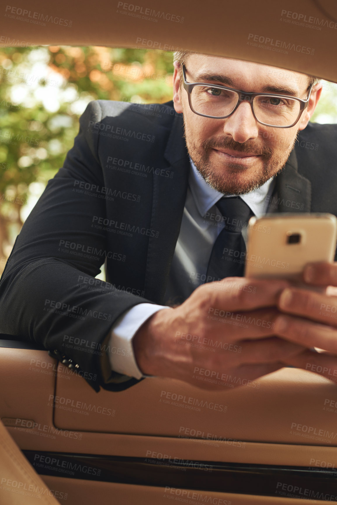 Buy stock photo Leaning, car and man with smartphone, employee and connection with typing, digital app and social media. Vehicle service, happy person and entrepreneur with cellphone, mobile user and communication