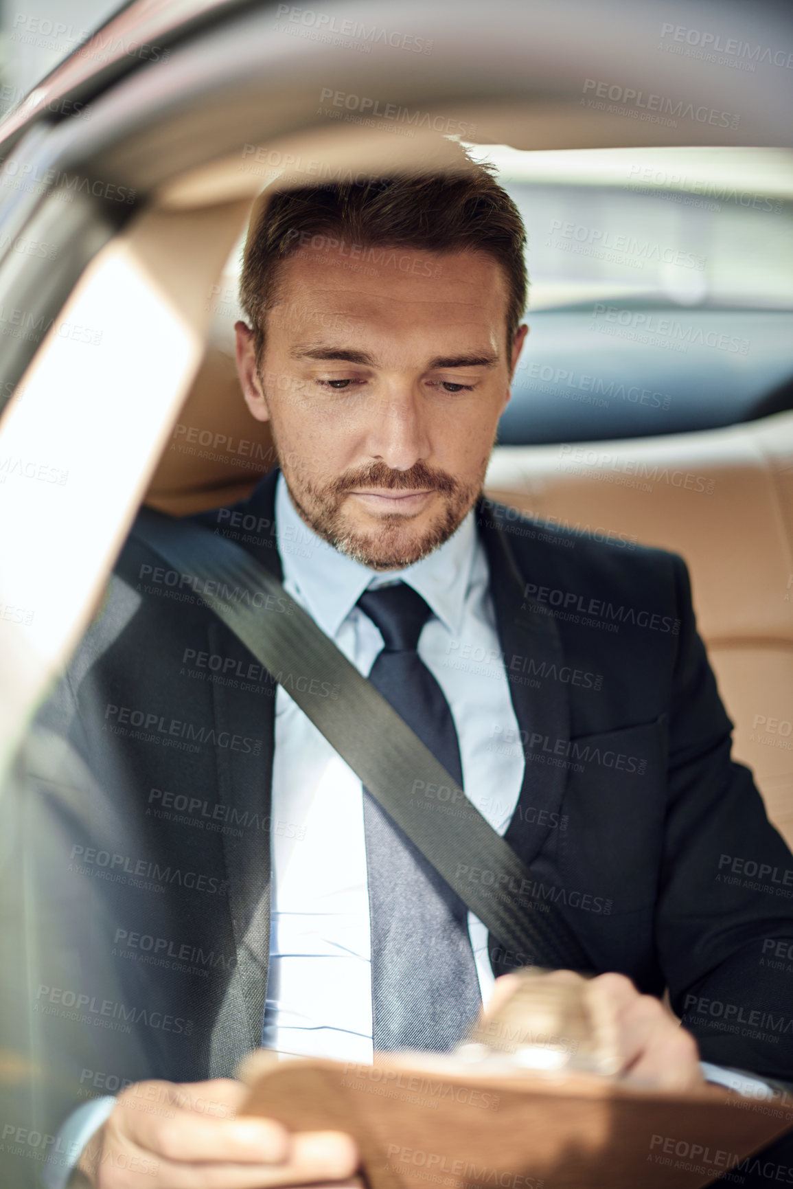 Buy stock photo Businessman, reading and checking with list in car for proposal, commute or travel to work in city. Man or employee with documents or paperwork in vehicle for road trip, opportunity or preparation