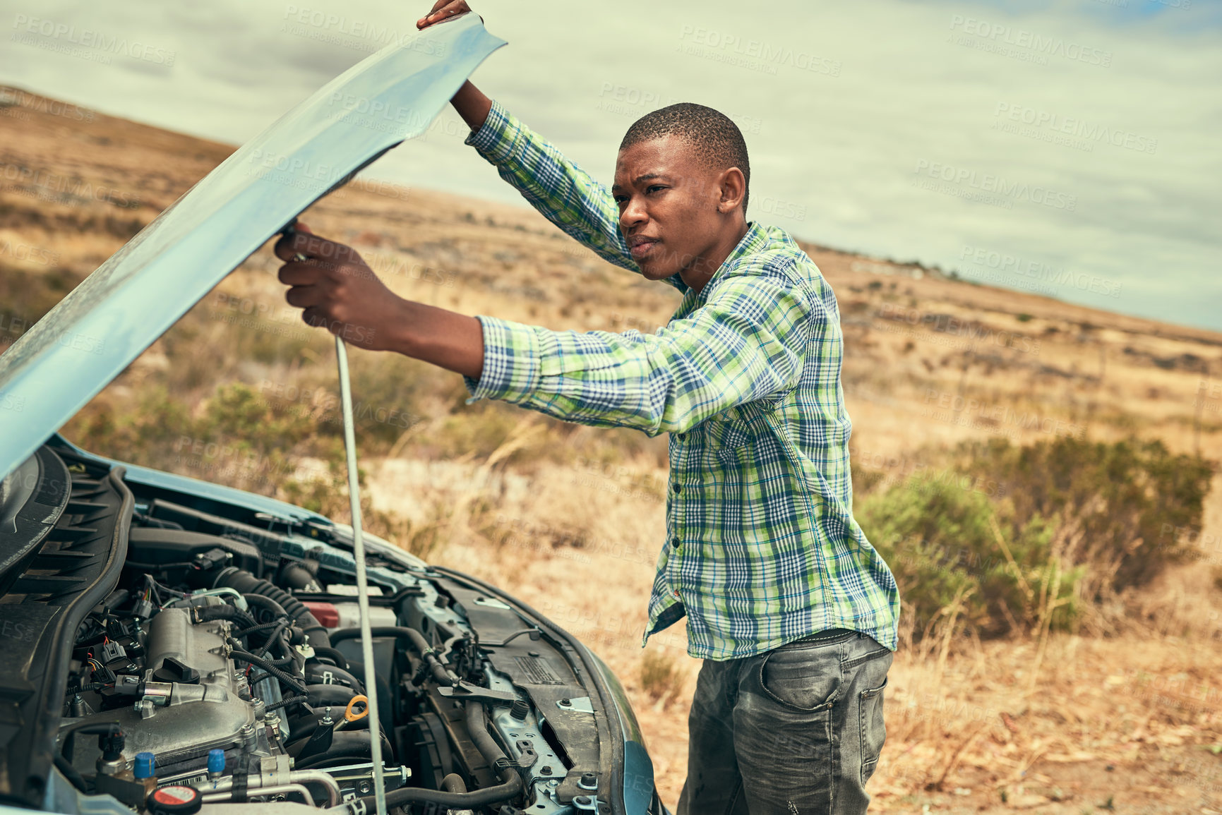 Buy stock photo Black man, engine and check car hood on road, outdoor and roadside assistance for auto service. Male person, battery and power issue with vehicle on street, cables and driver for transport emergency
