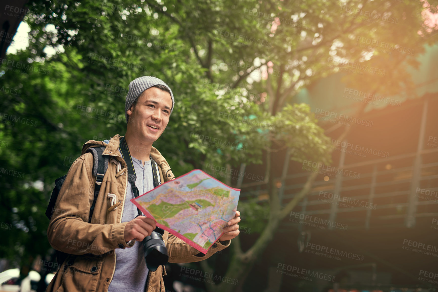 Buy stock photo Asian man, map and city travel for directions or urban sightseeing in China, searching or reading. Male person, paper and guide for outdoor tourism for weekend journey or park, location or geography