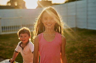 Buy stock photo Portrait of a happy brother and sister playing together in their backyard
