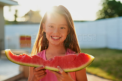 Buy stock photo Portrait of a happy young girl eating a slice of watermelon in the backyard