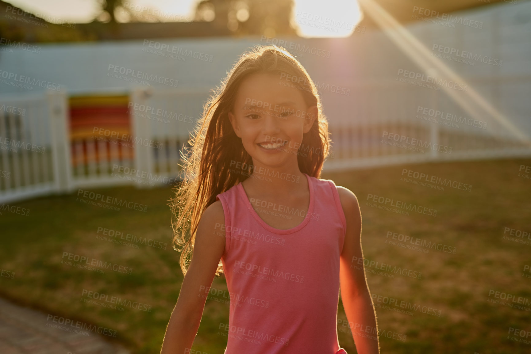 Buy stock photo Children, portrait and happy girl in backyard for sunset games, learning or having fun on vacation, break or holiday. Smile, face or kid in Indonesia with freedom, adventure on playground or garden
