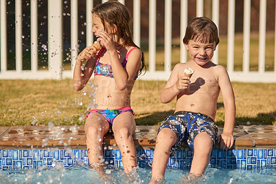 Buy stock photo Shot of a happy brother and sister having fun at the pool