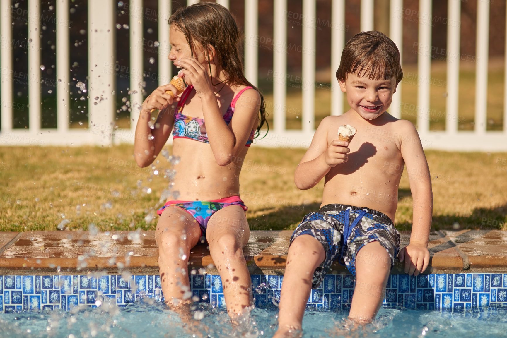 Buy stock photo Shot of a happy brother and sister having fun at the pool