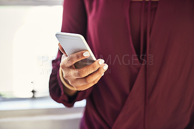 Buy stock photo Cropped shot of an unidentifiable businesswoman texting on a cellphone